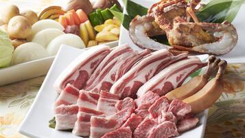 A plate of sliced meat, bananas, and various vegetables.