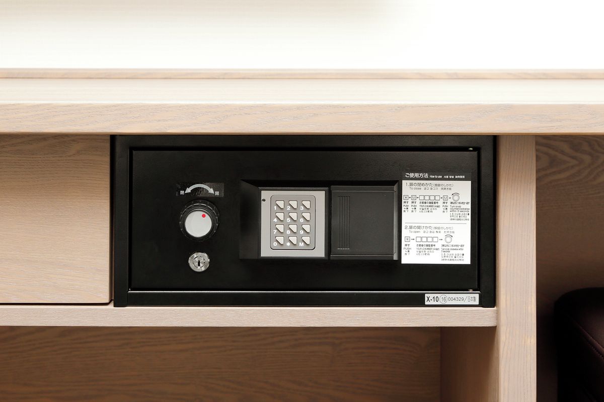 A secure safe with a combination dial, a keypad, and a lock mechanism.