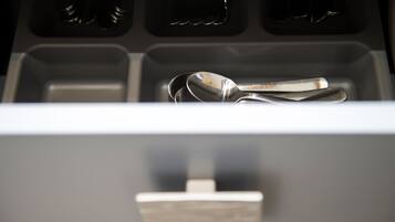 A drawer with a spoon inside.