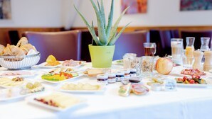 A buffet table with various food items and a potted aloe vera plant. - Parkhotel Styria (Steyr)