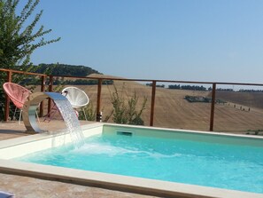 Outdoor pool, a waterfall pool, pool umbrellas, pool loungers