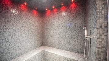 Enjoy a refreshing shower experience with a bench and handheld showerhead.