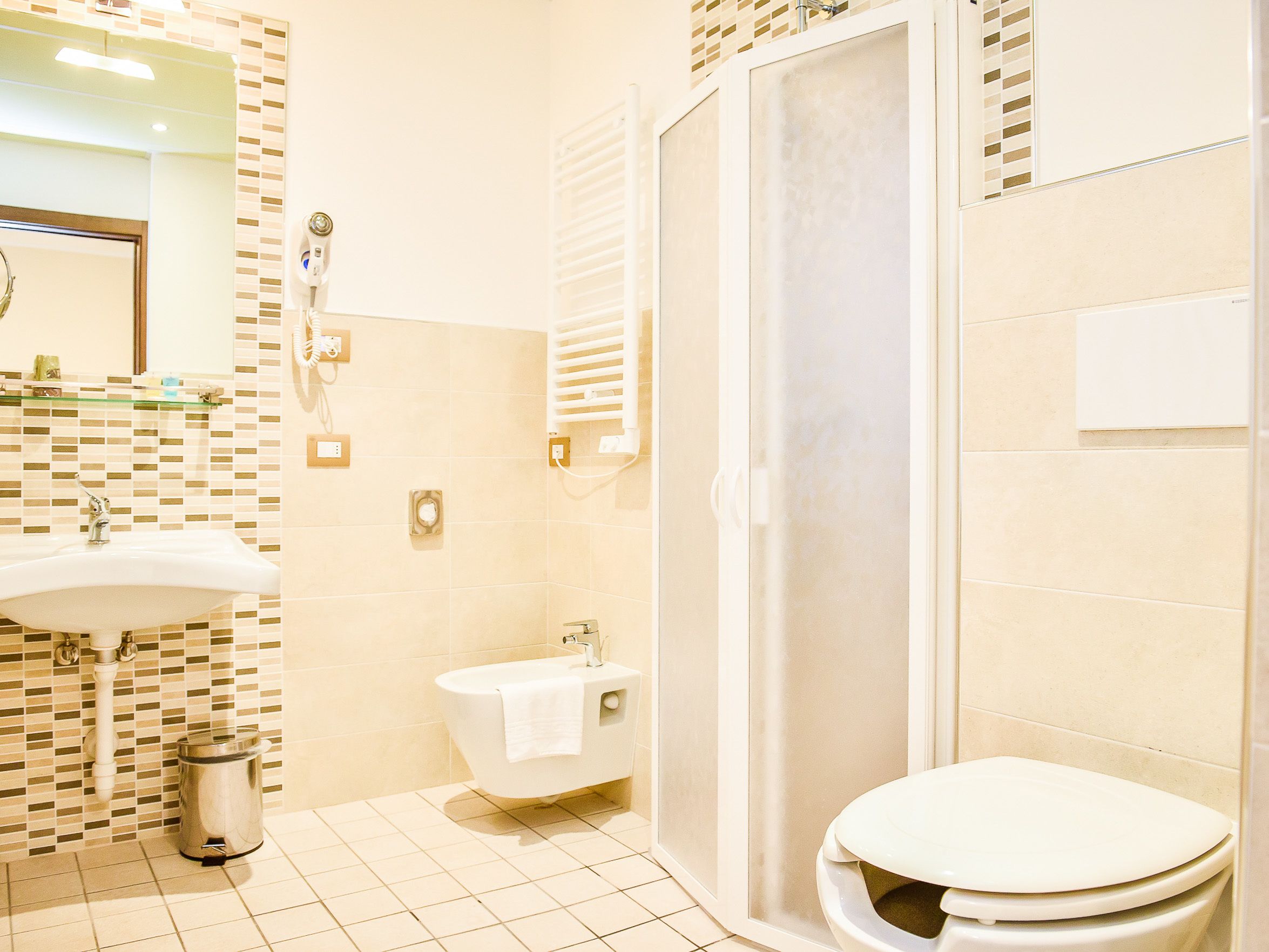 A bathroom with a sink, toilet, and shower.