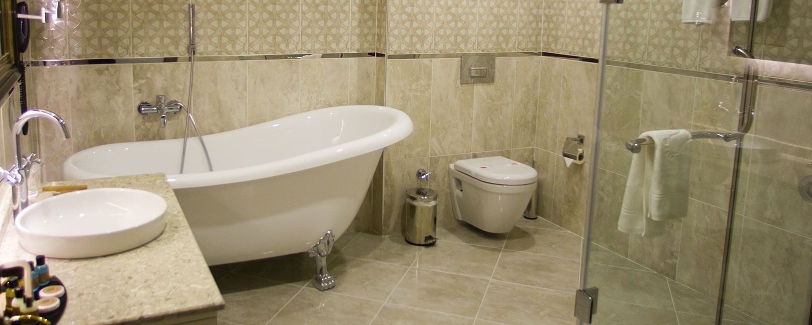 A bathroom with a freestanding bathtub, a toilet, and a sink.