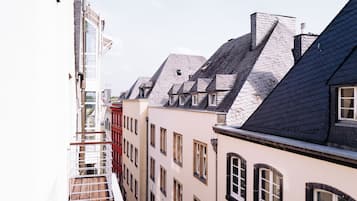 A row of buildings with steeply pitched roofs and multiple windows.