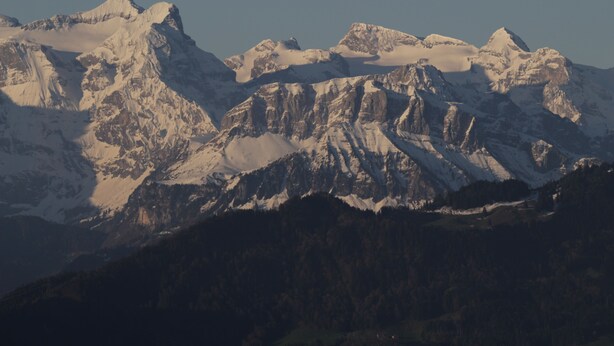 A mountainous landscape with snow-covered peaks and a forested valley. - The Outdoor Retreat (Oberaegeri)