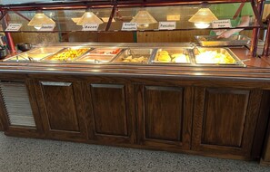 Enjoy a delicious breakfast spread with a variety of options, including Cream of Wheat, bacon, and scrambled eggs.