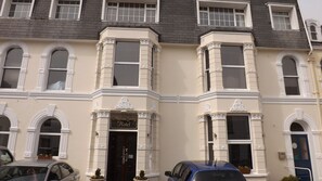 A corner building with a sign reading "Maison Gorey Hotel". - Maison Gorey Hotel (Grouville)