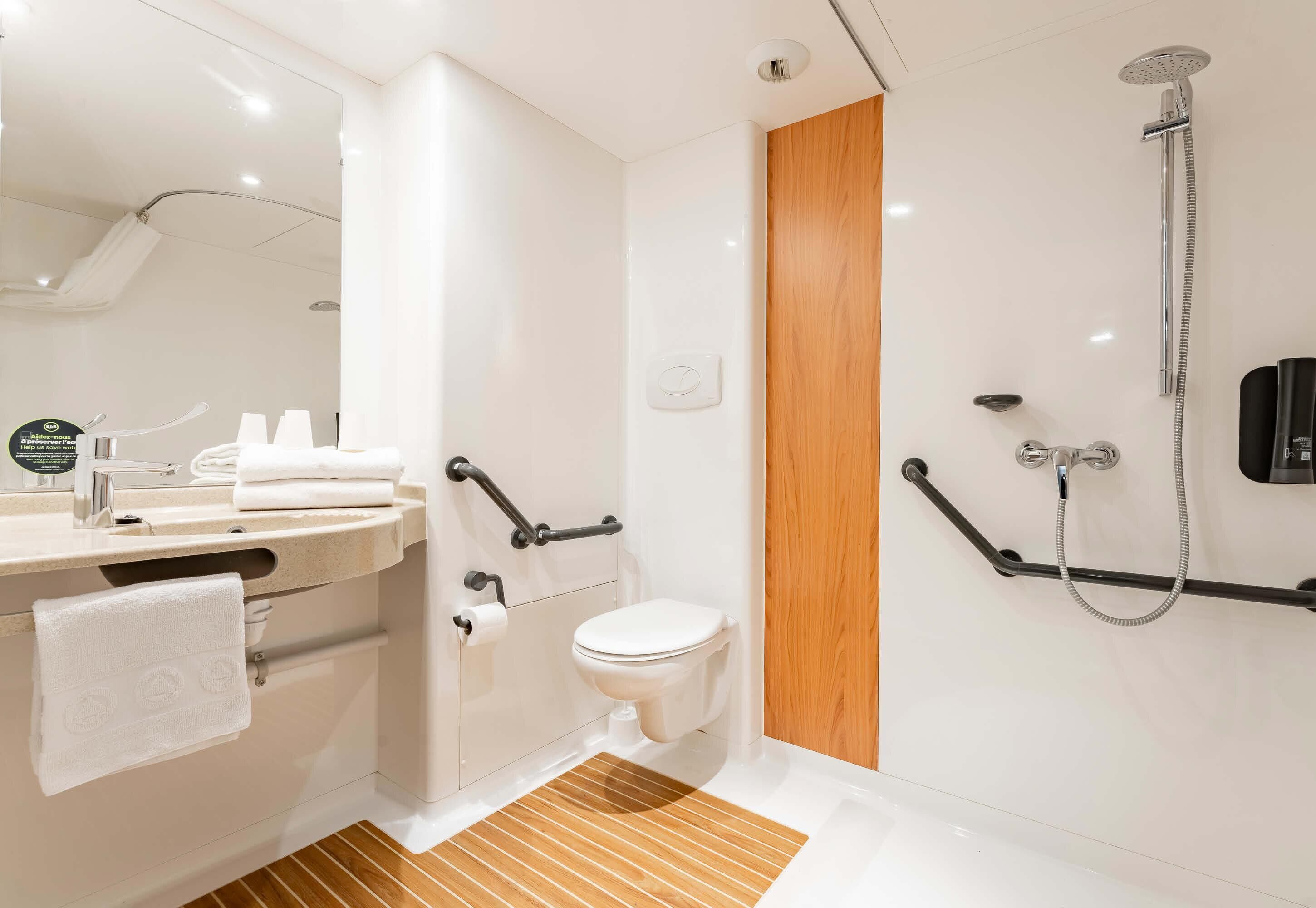 A modern bathroom with a toilet, bidet, and shower.