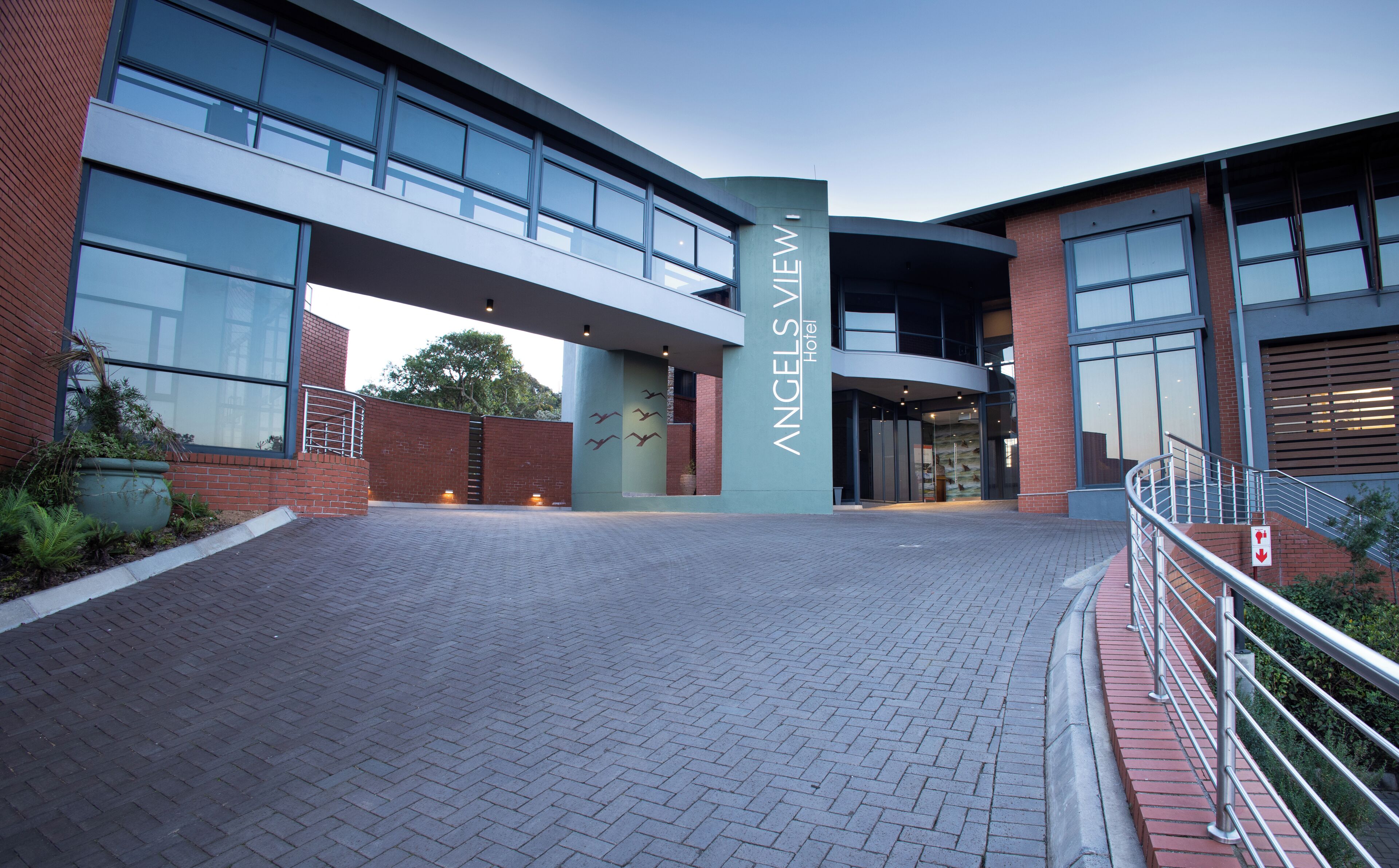 A modern hotel entrance with a prominent sign reading "ANGELS VIEW Hotel."