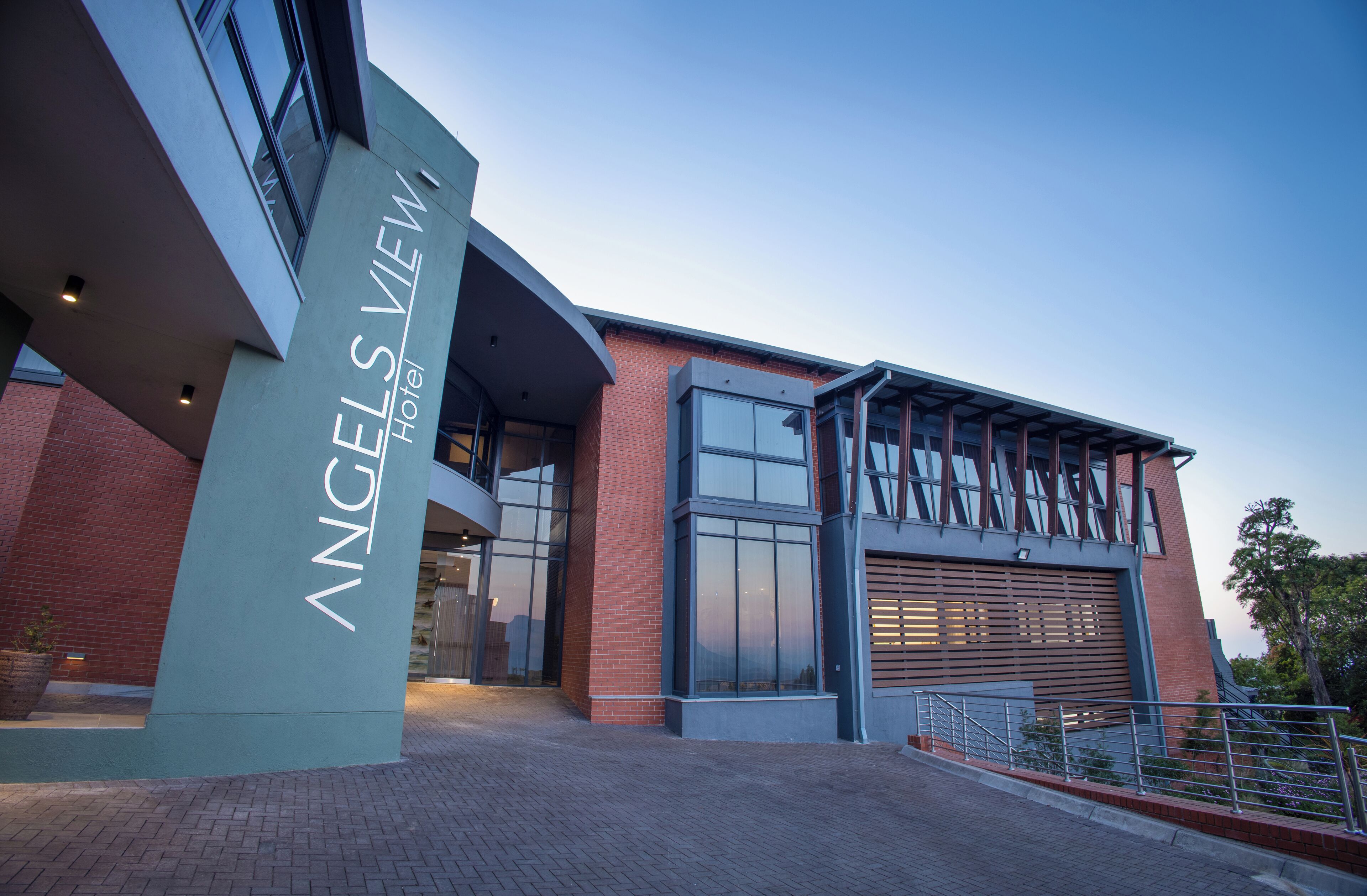 A modern hotel building with a prominent sign reading "Angels View Hotel."