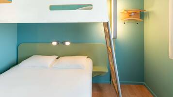 A bunk bed with a headboard, a bedside table, and a wall-mounted light fixture.