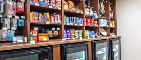 A refrigerated display case with various packaged goods and beverages.