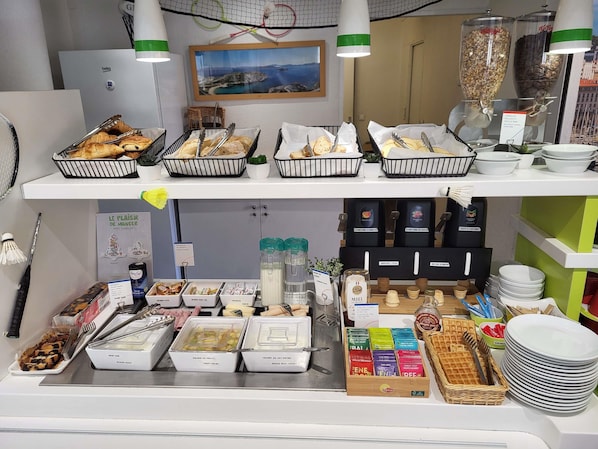 A breakfast buffet with various food items and condiments.