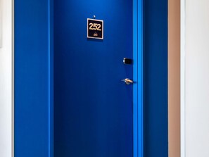 A blue door with a sign reading "252" and a small logo. - ibis budget Versailles Trappes (Trappes)