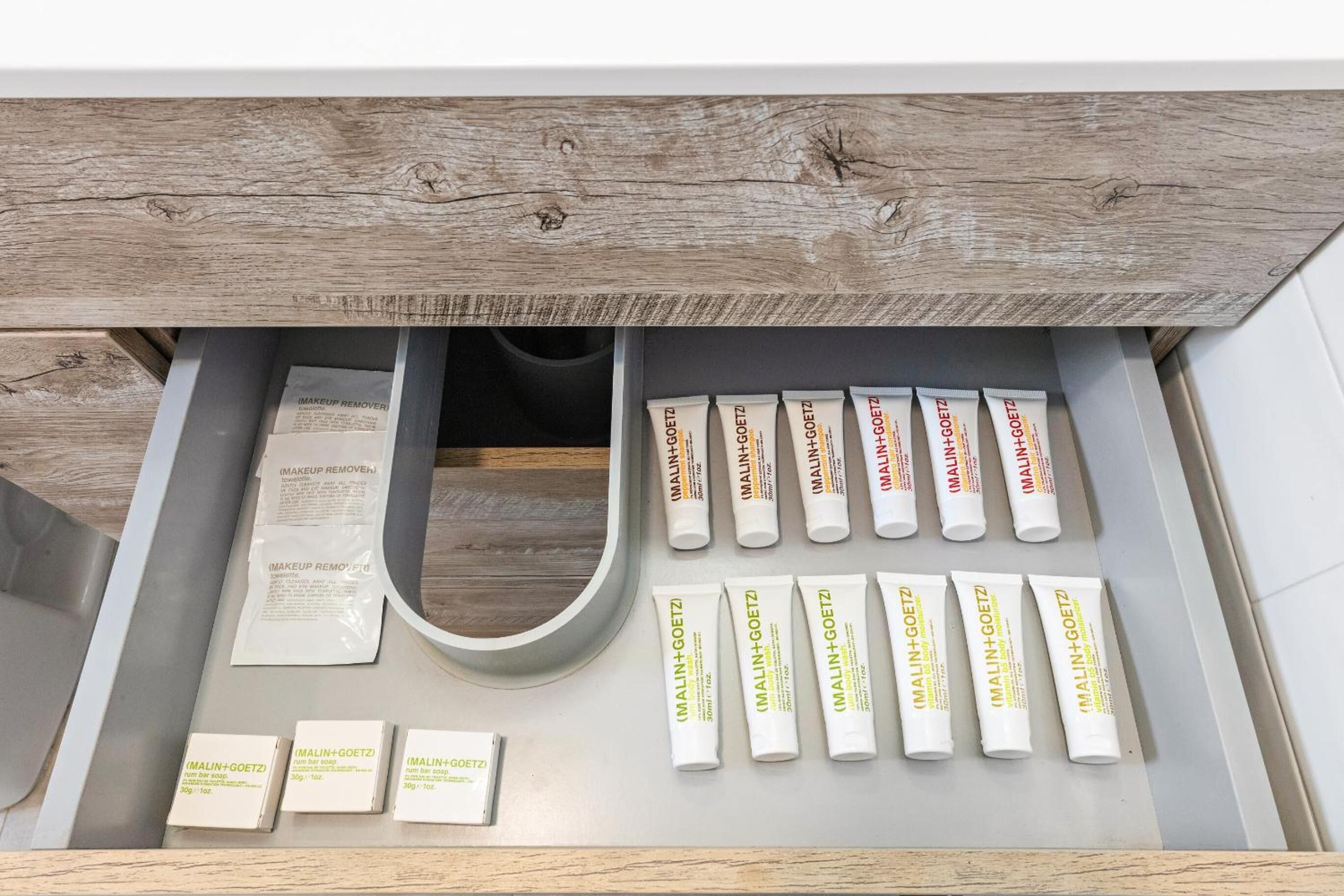 A drawer with makeup remover tubes and boxes.