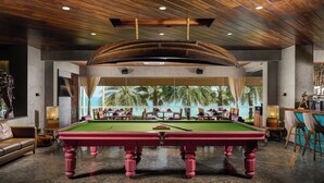 A pool table in a room with a wooden ceiling and a view of palm trees. - The Bheemli Resort - Managed by AccorHotels (Bhimunipatnam)