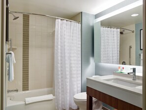 A modern bathroom with a bathtub, toilet, and shower area. - Hyatt Place Arlington/Courthouse Plaza (Arlington)