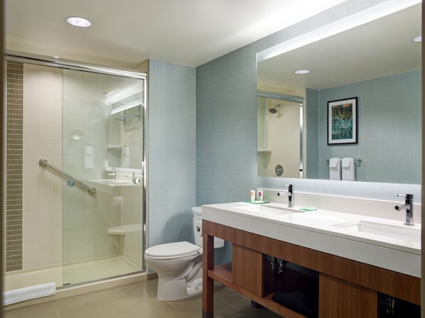 A modern bathroom with a glass shower enclosure, a white toilet, and a vanity with a mirror. - Hyatt Place Arlington/Courthouse Plaza (Arlington)