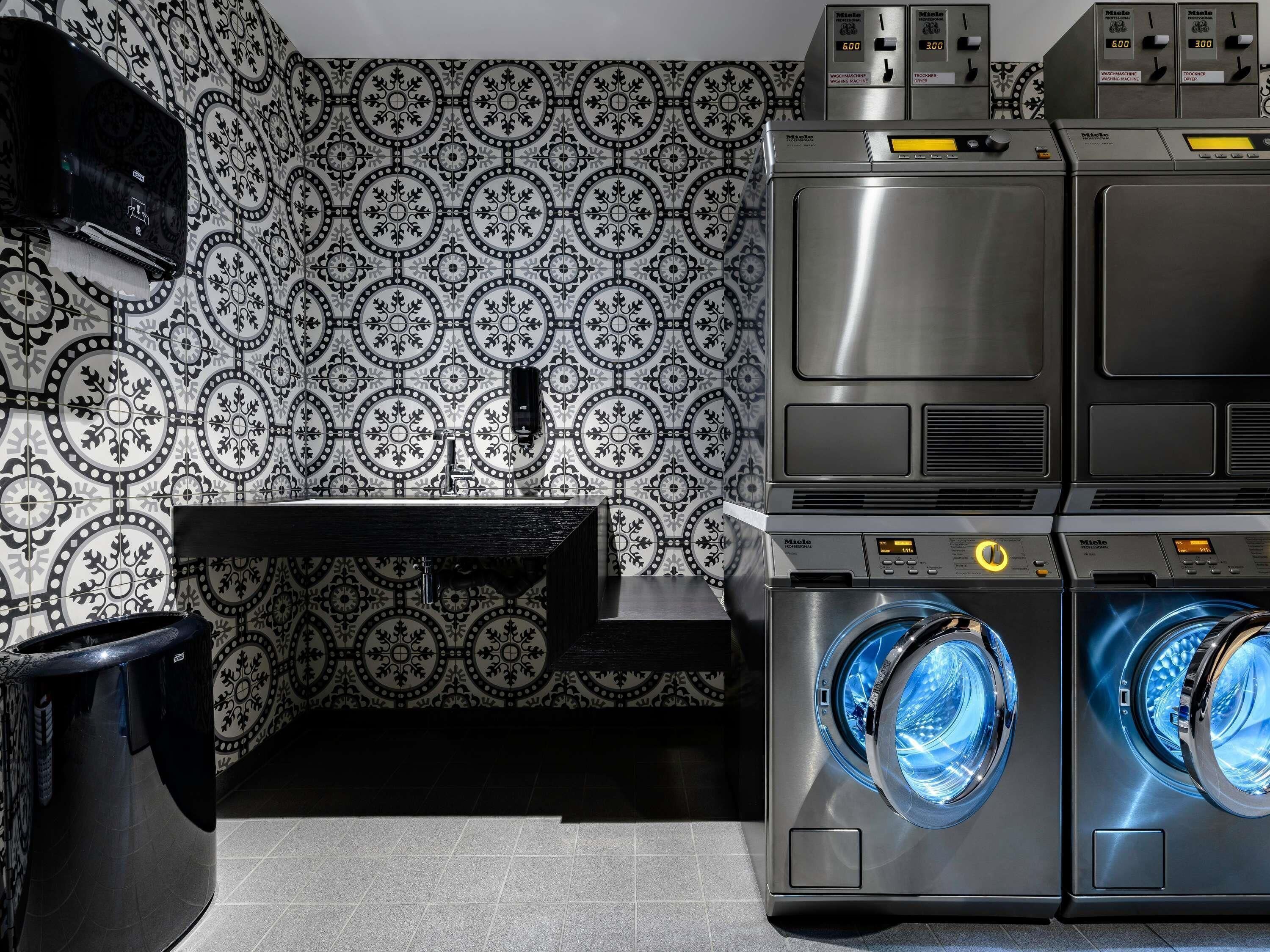 A laundry area with a washing machine, dryer, and a wall-mounted air conditioning unit.