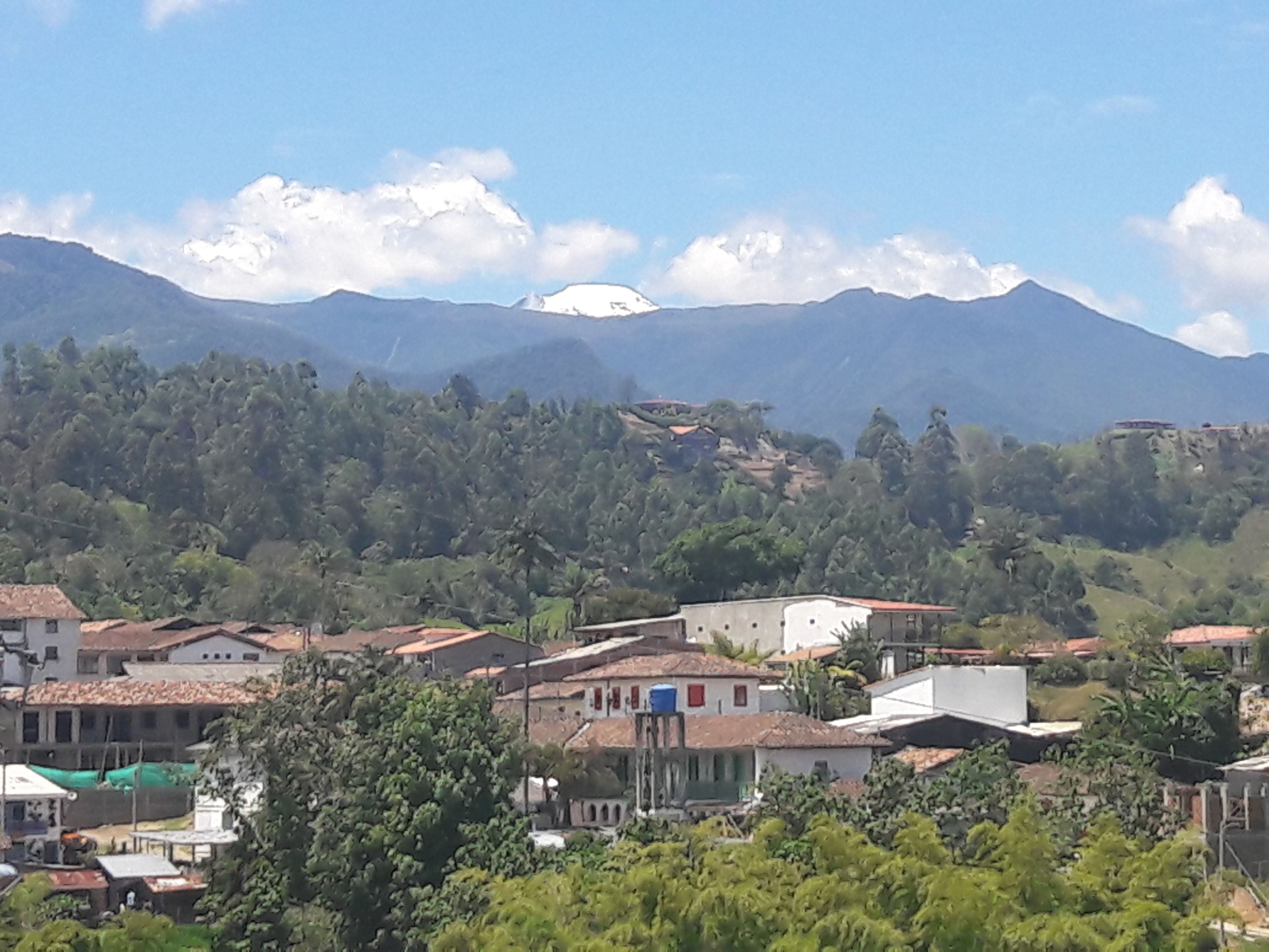 A mountainous landscape with a village in the foreground.
