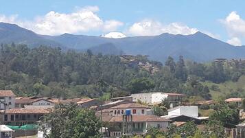 A mountainous landscape with a village in the foreground.