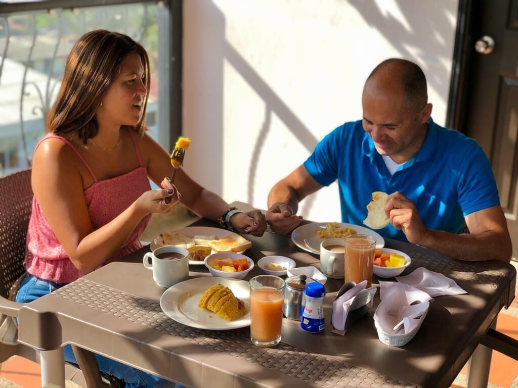 A dining table with breakfast items including toast, fruit, coffee, and juice.
