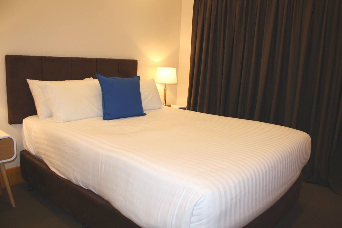 Premium bedding, blackout curtains, soundproofing, iron/ironing board