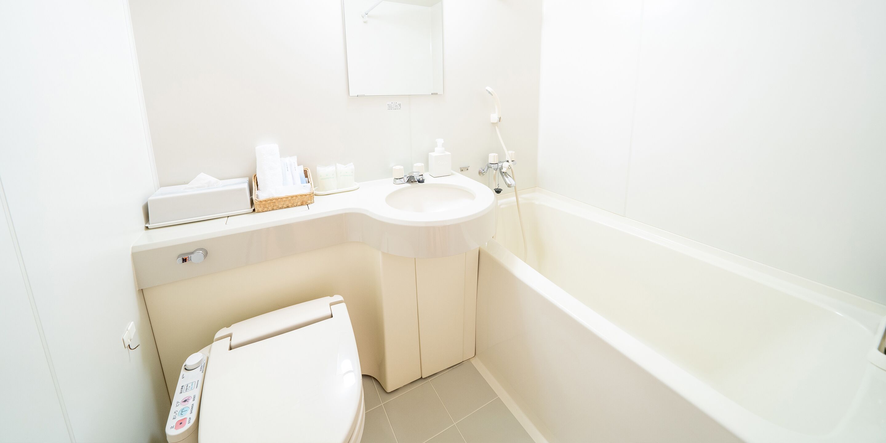 A modern bathroom with a toilet, sink, and bathtub.