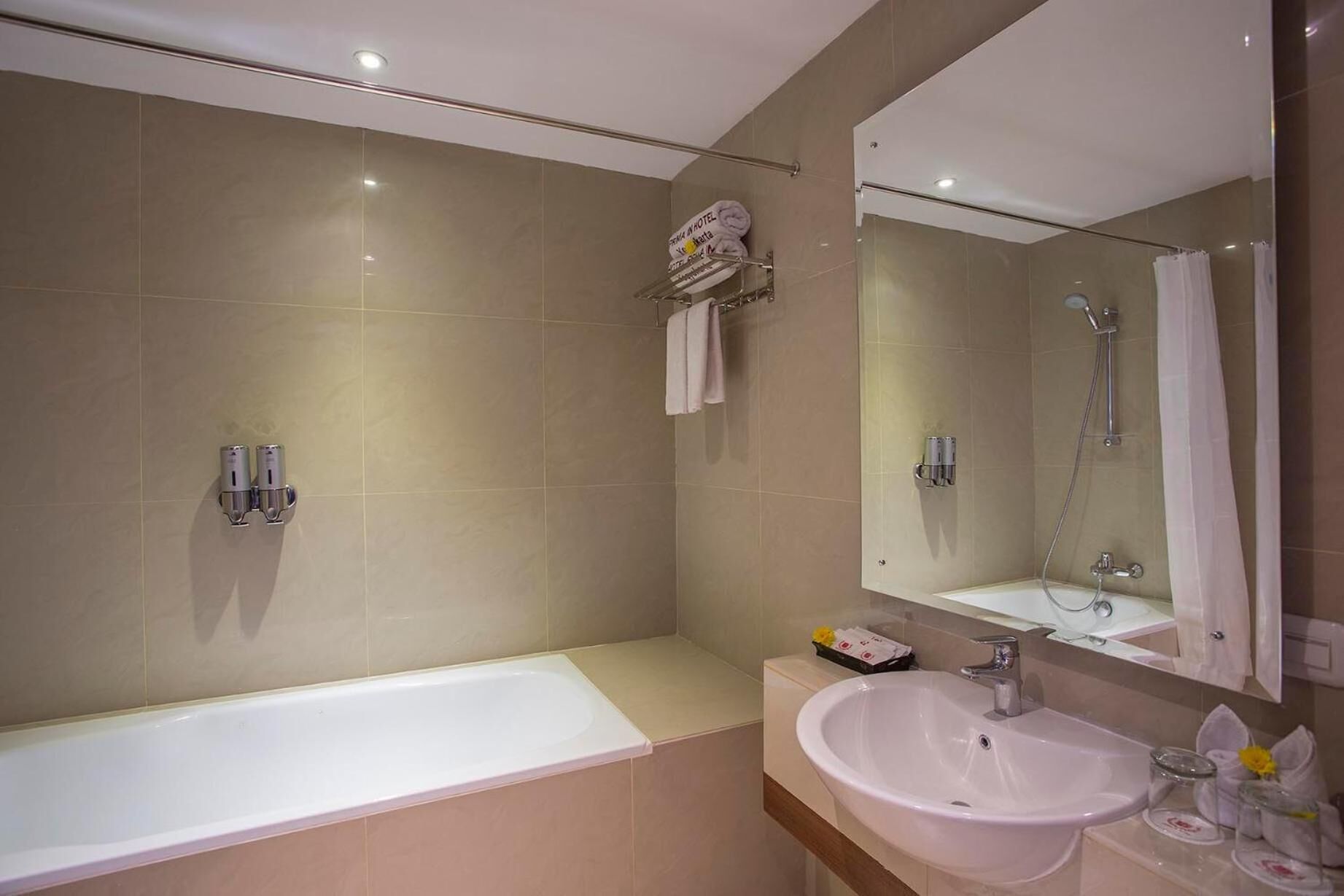 A modern bathroom with a bathtub, a sink, and a shower.