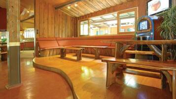 A restaurant with wooden walls and benches.