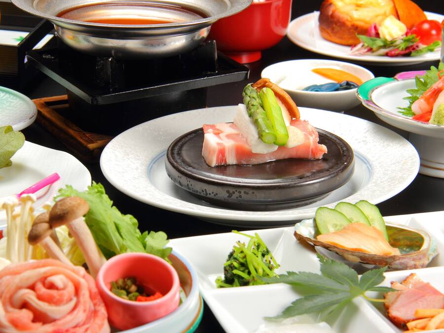 A variety of dishes including sushi, sashimi, and vegetables, suggesting a Japanese dining experience.