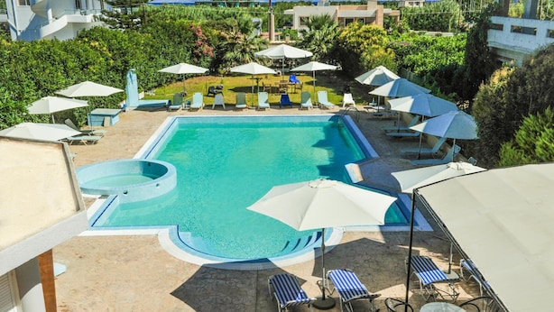 A pool area with lounge chairs, umbrellas, and a clear blue pool. - Valentino Hotel (Rhodes)
