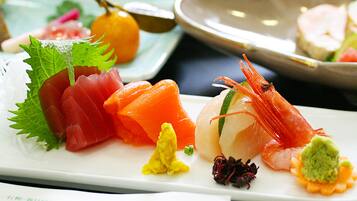 A variety of sushi dishes on a white plate.