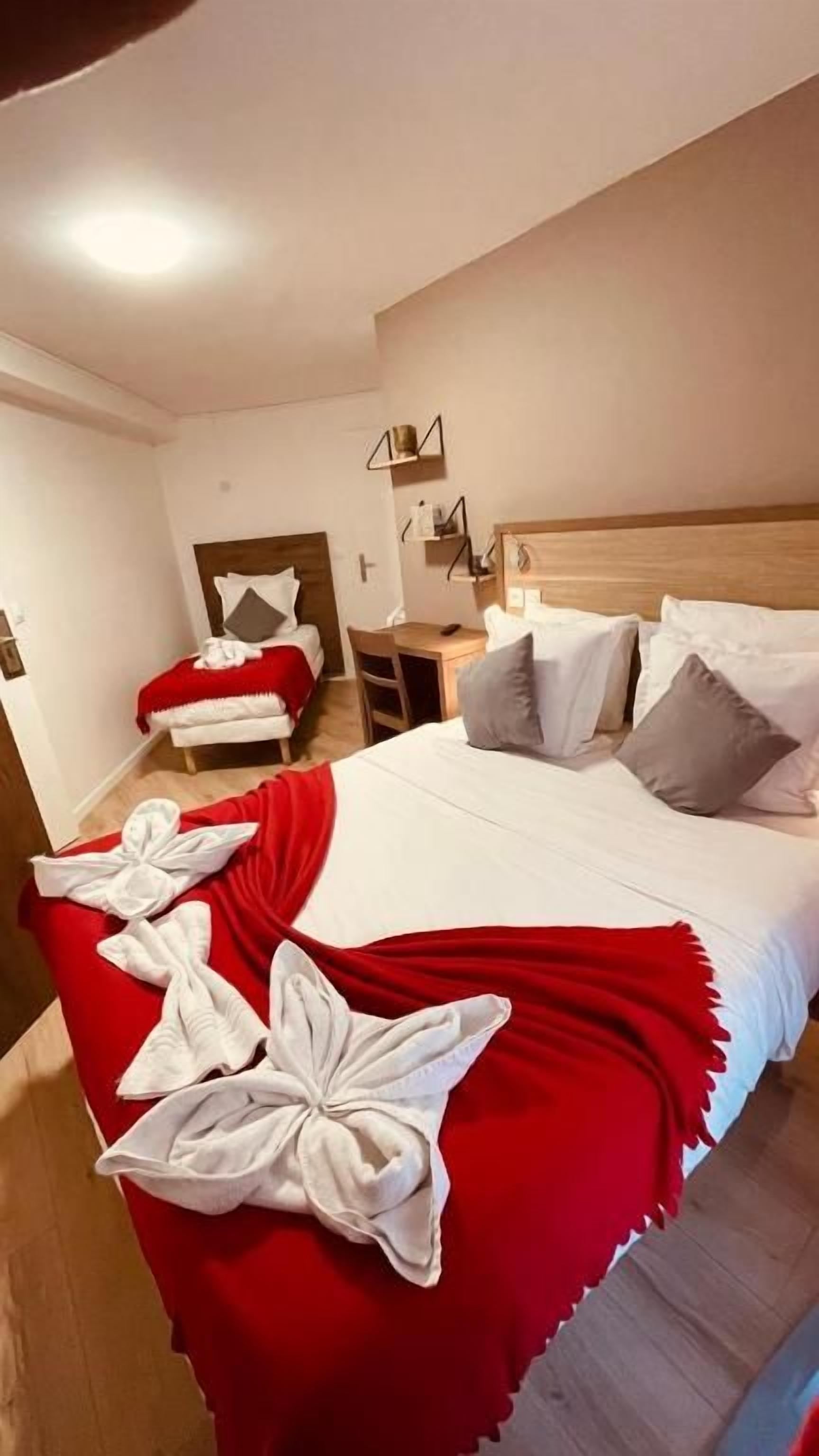 Una habitación de hotel con una cama grande, un escritorio y una silla.