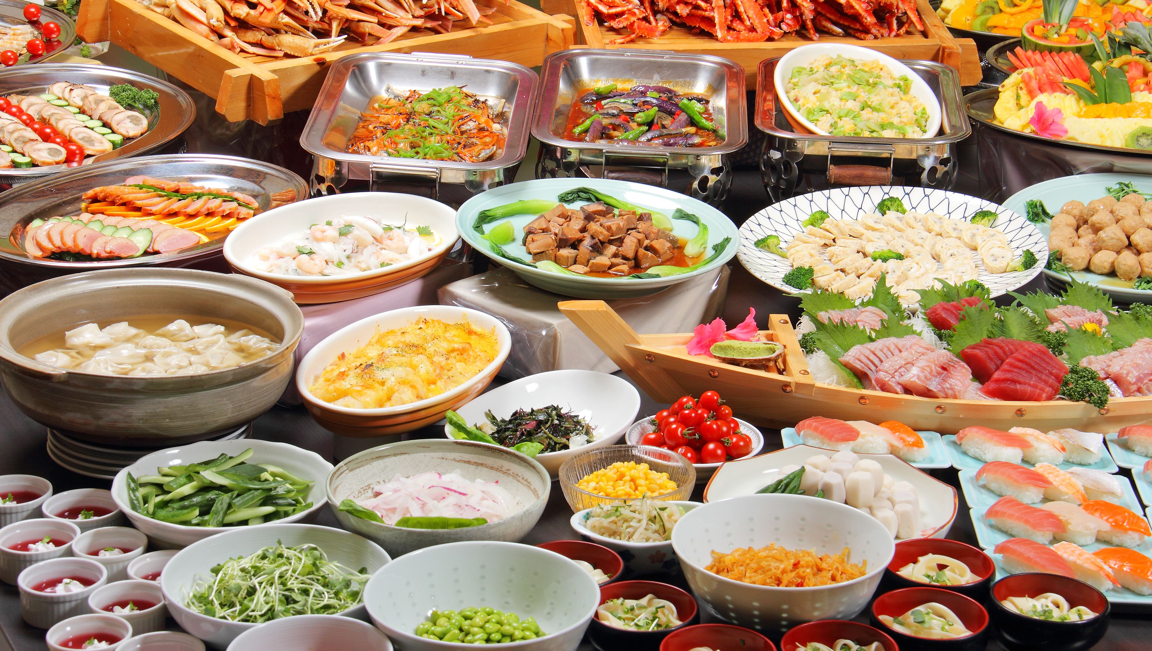A buffet with various dishes including seafood, vegetables, and Asian cuisine.