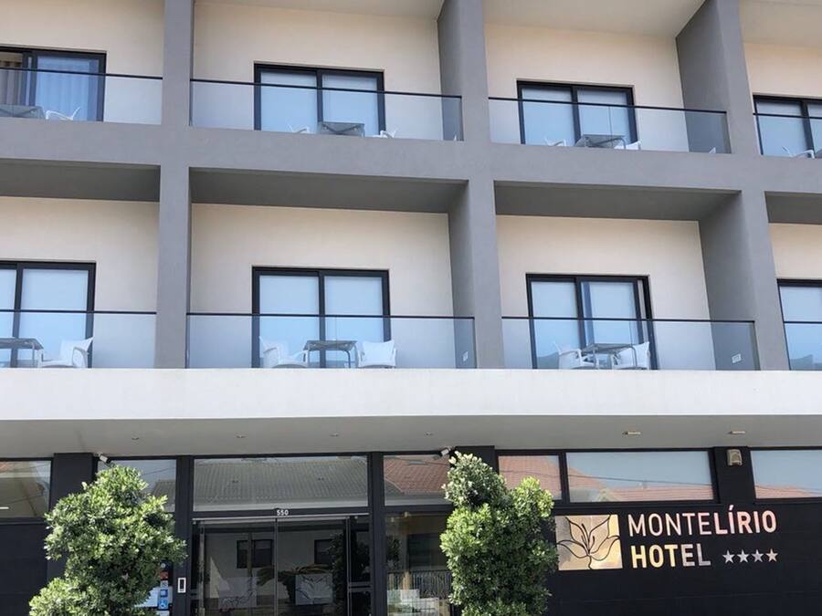 A hotel with a modern facade, multiple balconies, and a clear entrance.