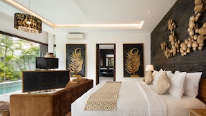 A modern bedroom with a large bed, a TV, a wooden nightstand, and a view of a swimming pool. - Canggu Villa by Sanga Sanga Hospitality (Canggu)