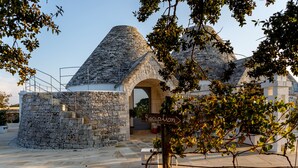 Un bâtiment en pierre doté d’un toit conique et d’une entrée en arc de cercle.