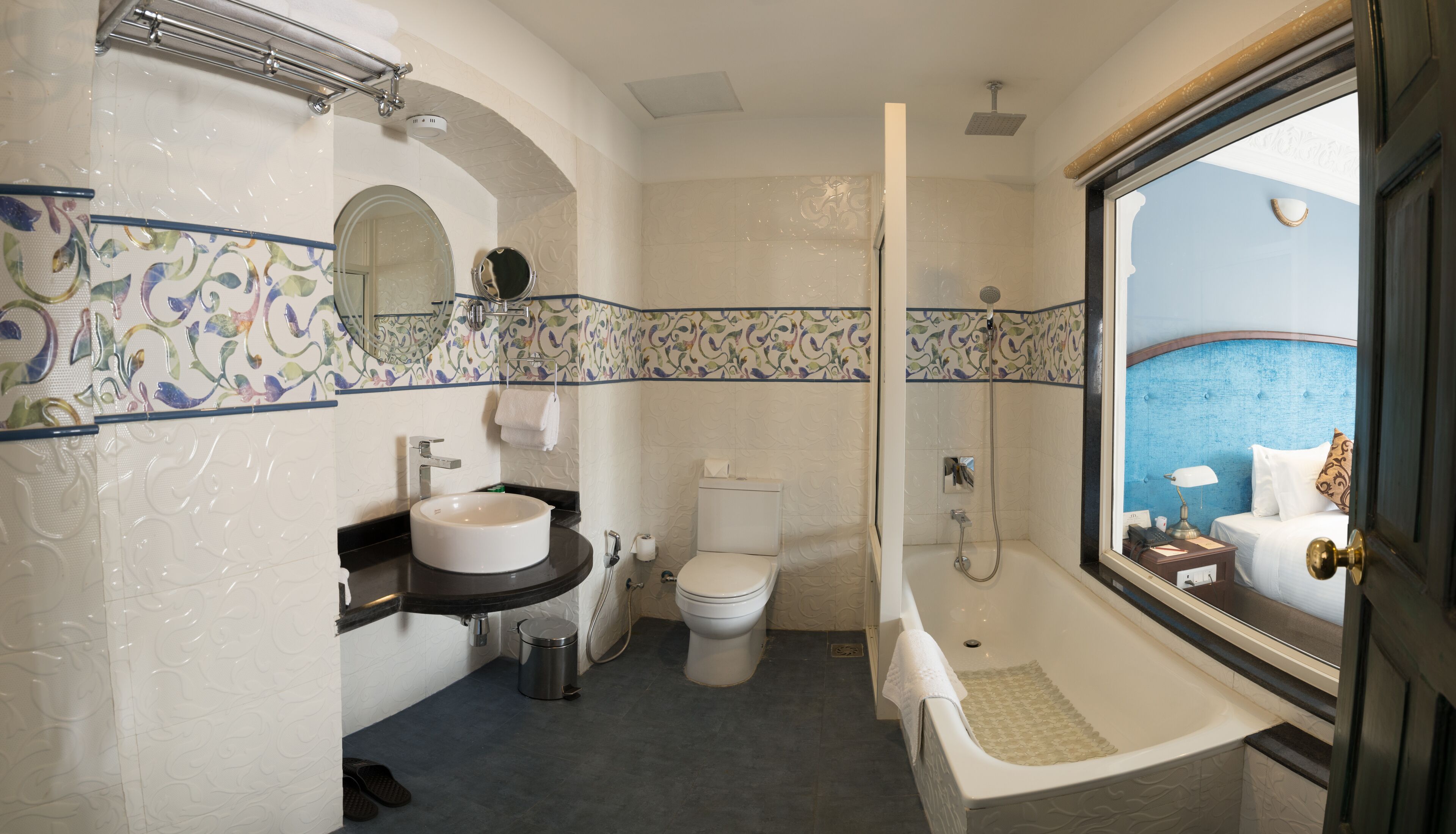 A bathroom with a bathtub, toilet, sink, and a shower.