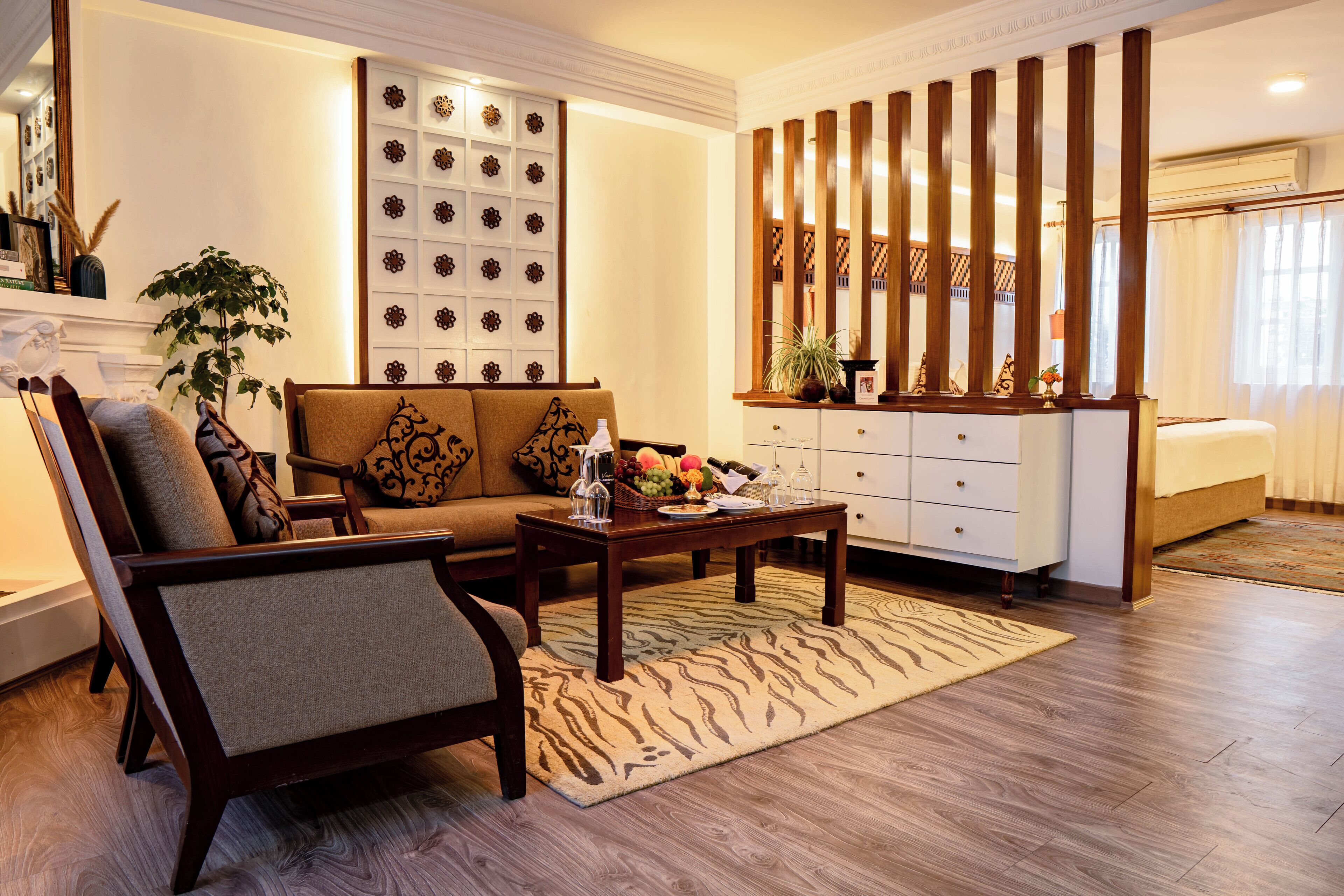 A living room with a sofa, coffee table, and decorative wall panel.