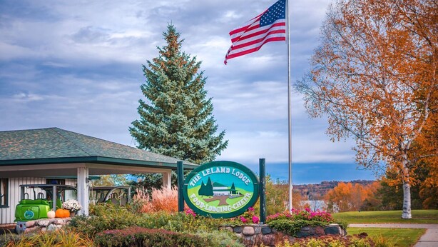 Het bord van Leland Lodge, een gebouw met een groen dak, en een Amerikaanse vlag.