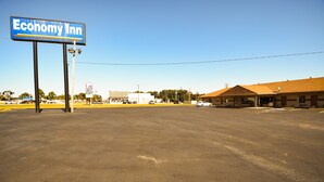 A large parking lot with a sign for Economy Inn, a Taco Bell, and a building with a brown roof. - Economy Inn Beebe (Beebe)