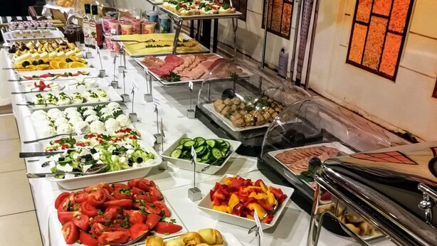 A buffet spread with various food items and condiments. - Przystanek Toruń (Torun)