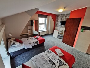 A dormitory room with two beds, a desk, a chair, a mirror, and a window. - Przystanek Toruń (Torun)