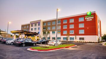 A Holiday Inn Express hotel with multiple parking spaces and a well-lit entrance.
