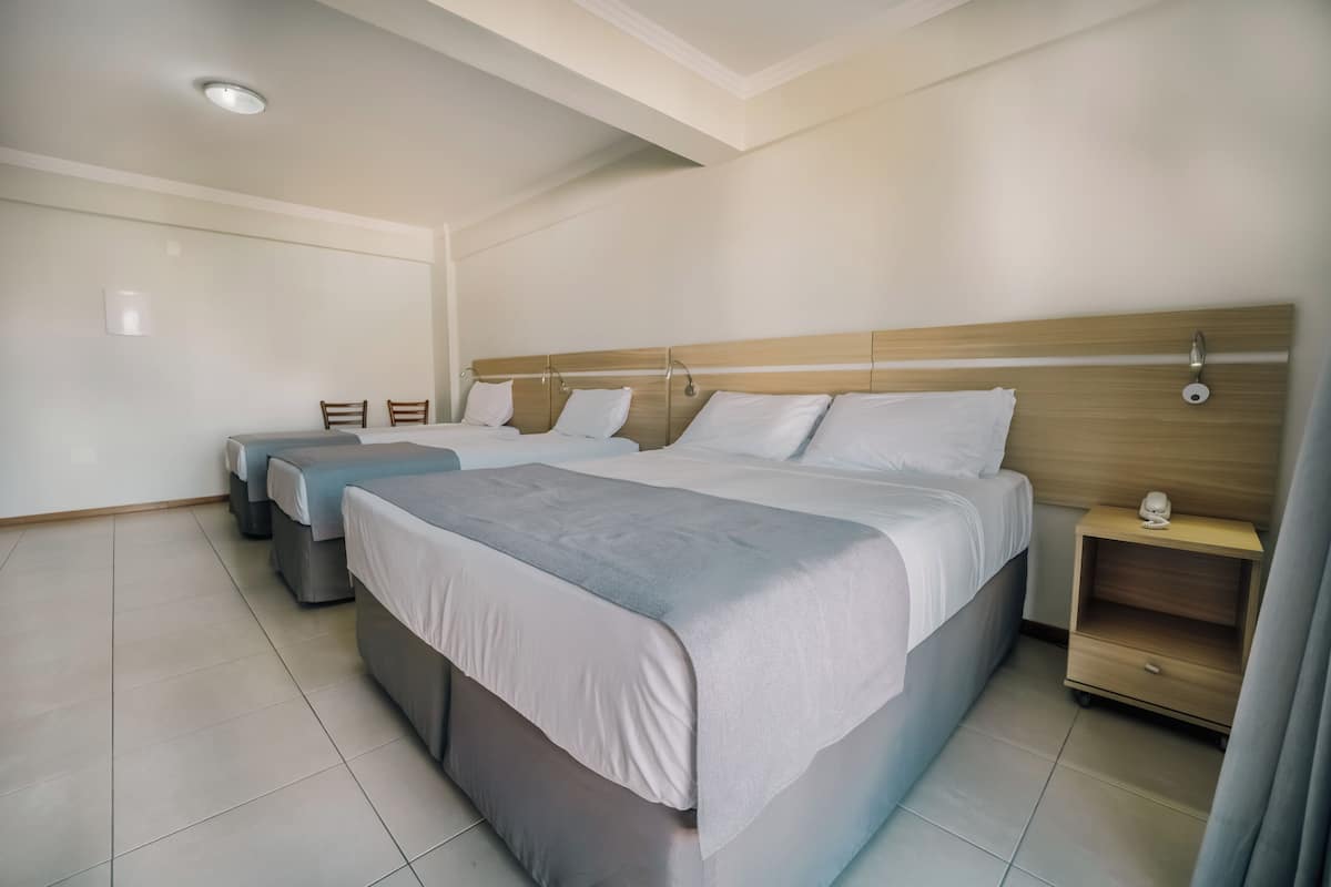 Standard Quadruple Room | Minibar, in-room safe, laptop workspace, blackout drapes