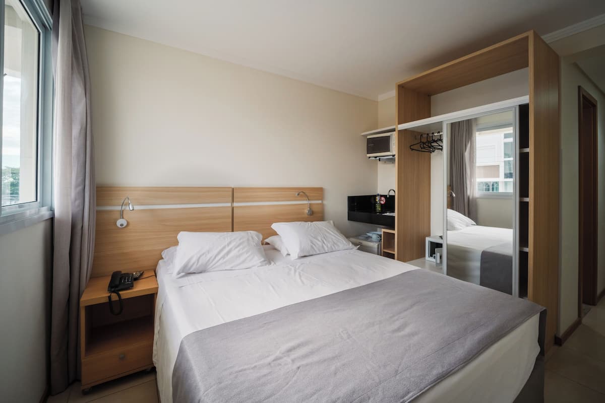 Economy Double Room | Minibar, in-room safe, laptop workspace, blackout drapes