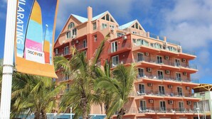A multi-story hotel with balconies and air conditioning units. - Sea Palace (Philipsburg)
