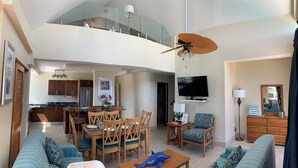 A spacious living area with a dining table, chairs, sofas, a TV, and a ceiling fan. - Sea Palace (Philipsburg)